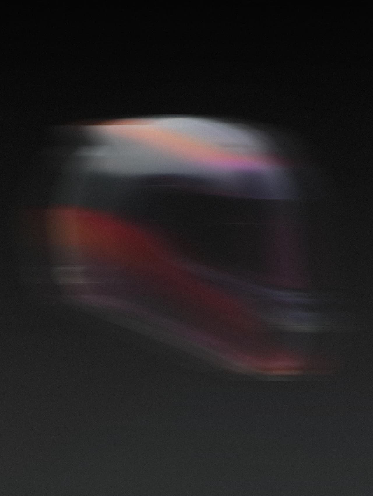 A motorcycle helmet streaked with motion blur, already moving on.